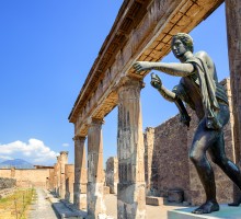 Ruins of the antique Temple of Apollo with bronze Apollo statue in Pompeii, Naples, Italy