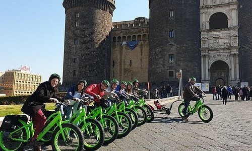 A group of toursits on green ebike's